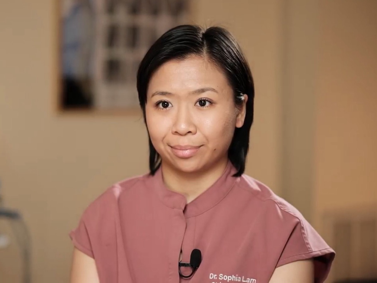 Dr. Sophia Lam, D.C. at her Bayside chiropractic office explaining spinal adjustment